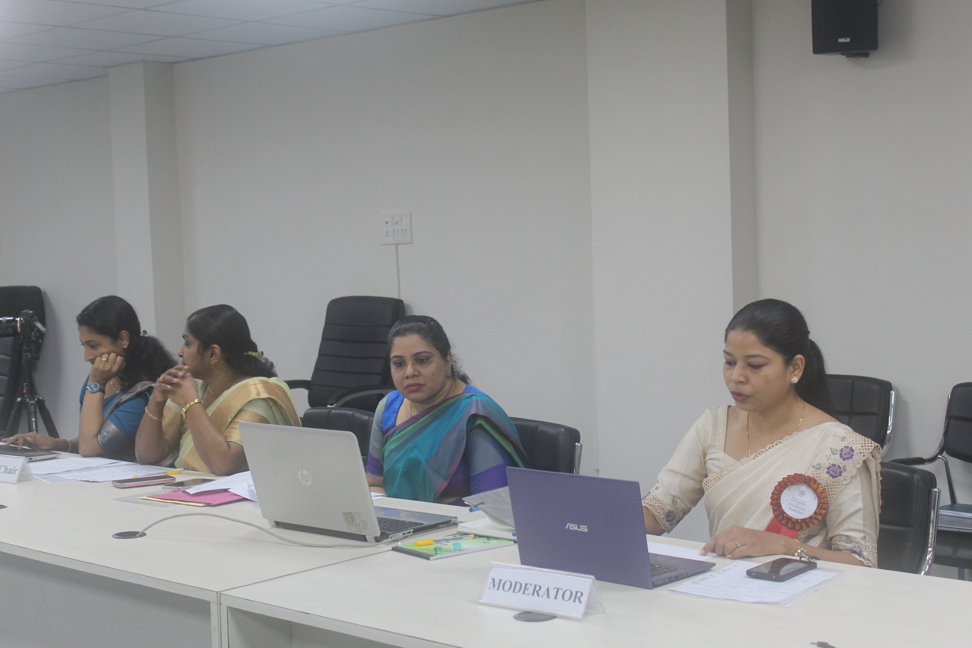 Moderator and faculty at the session desk